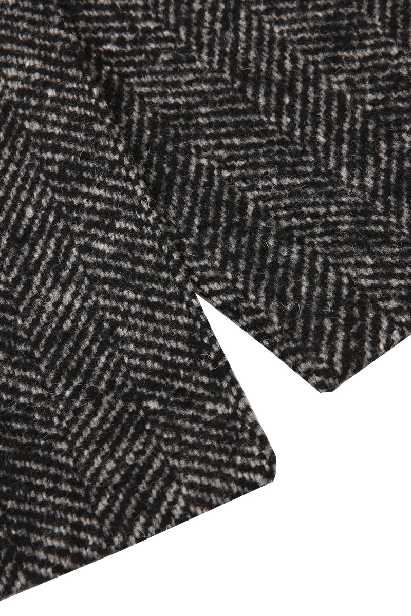 Close-up of a textured fabric with a herringbone pattern on a white background