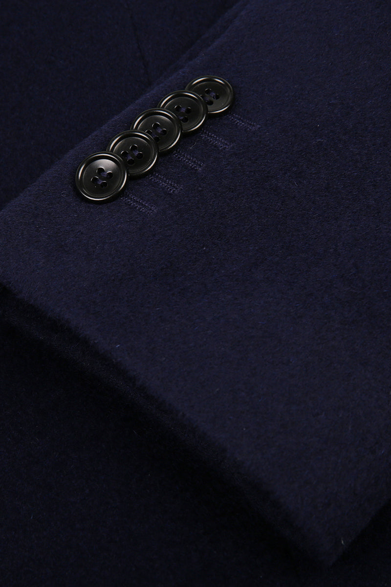 Close-up of a navy blue fabric with buttons on a dark background