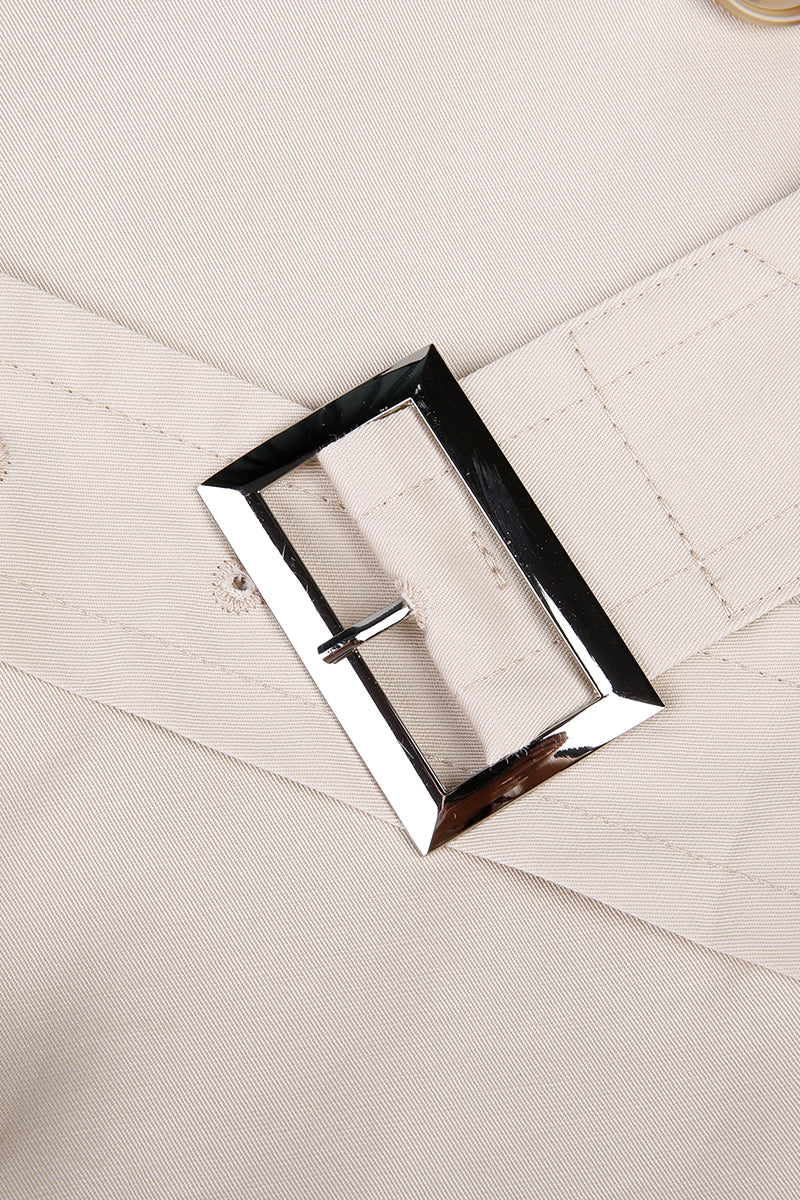 Close-up of a silver belt buckle on beige fabric custom made suits for women