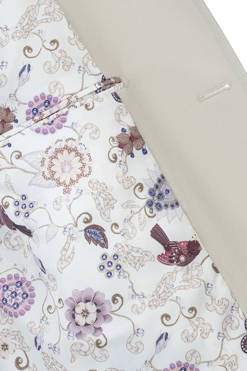 Floral and paisley patterned fabric with a hanger on a light background