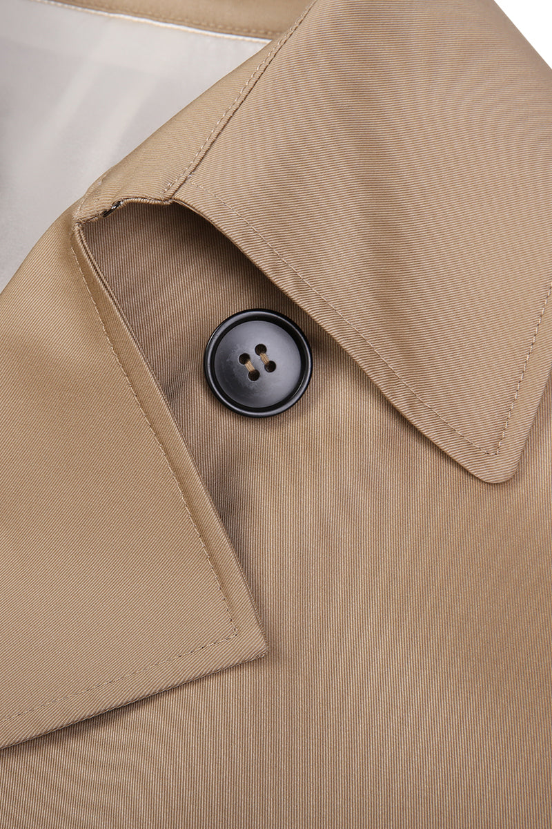 Close-up of a beige trench coat with a button on a white background