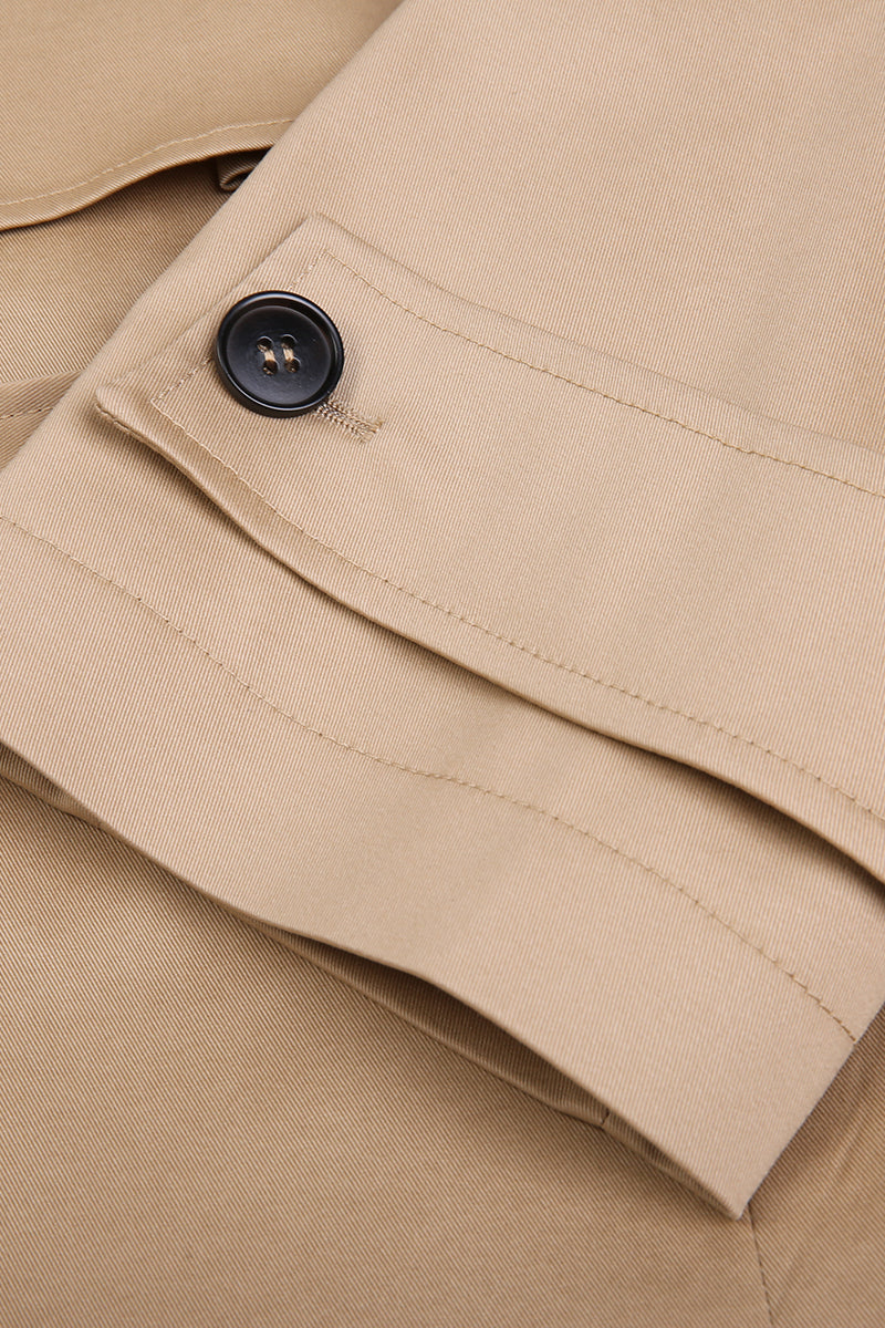 Close-up of beige fabric with a button detail