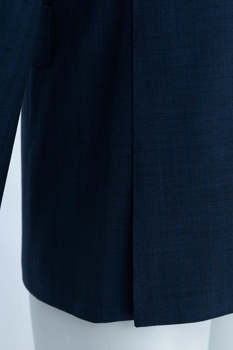 Navy blue coat on a mannequin against a white background