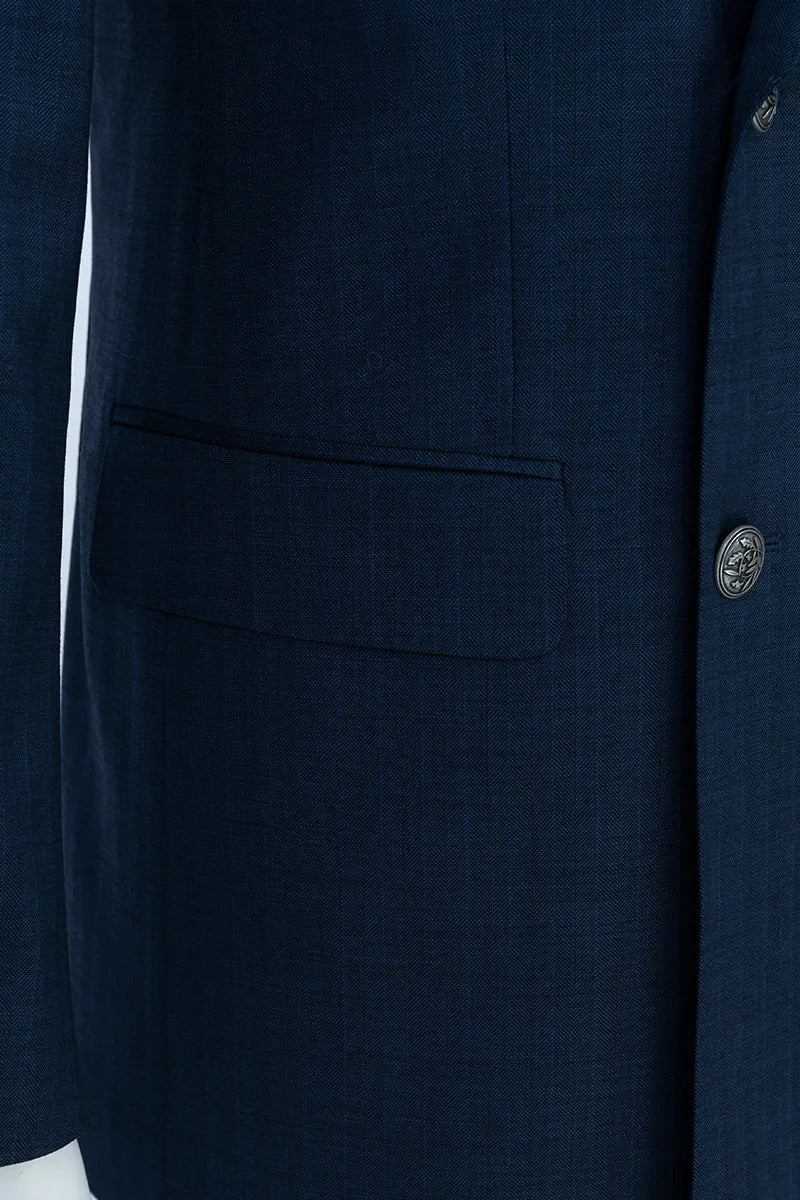 Close-up of a navy blue suit jacket with a pocket and button.