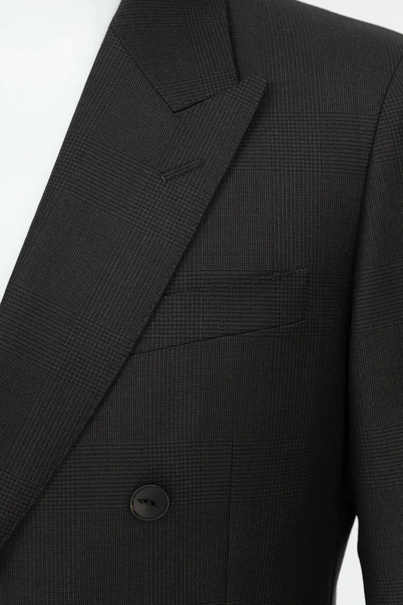 Close-up of a black suit jacket with a button on a white background