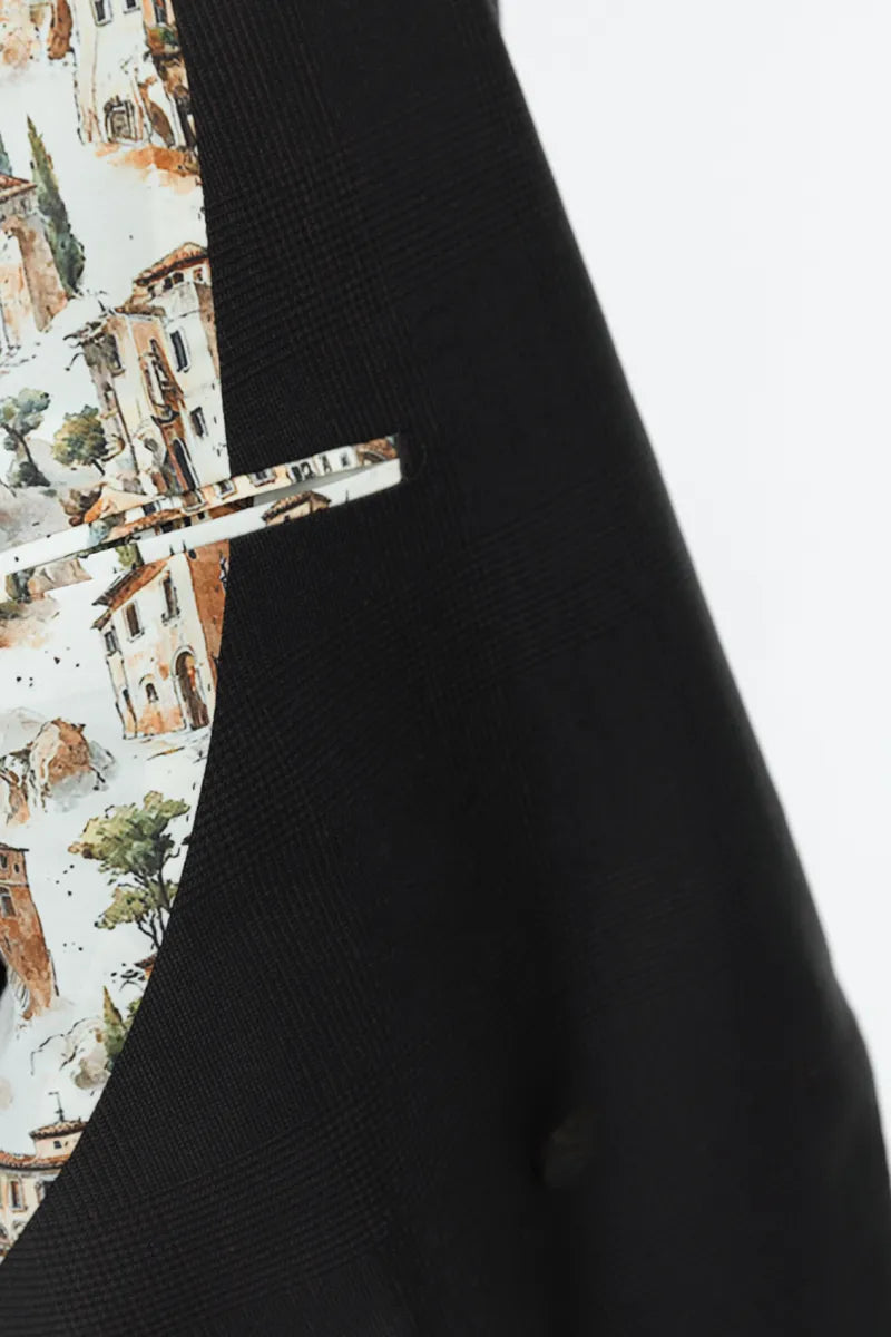 Close-up of a black garment with a patterned pocket on a white suit lining blazer