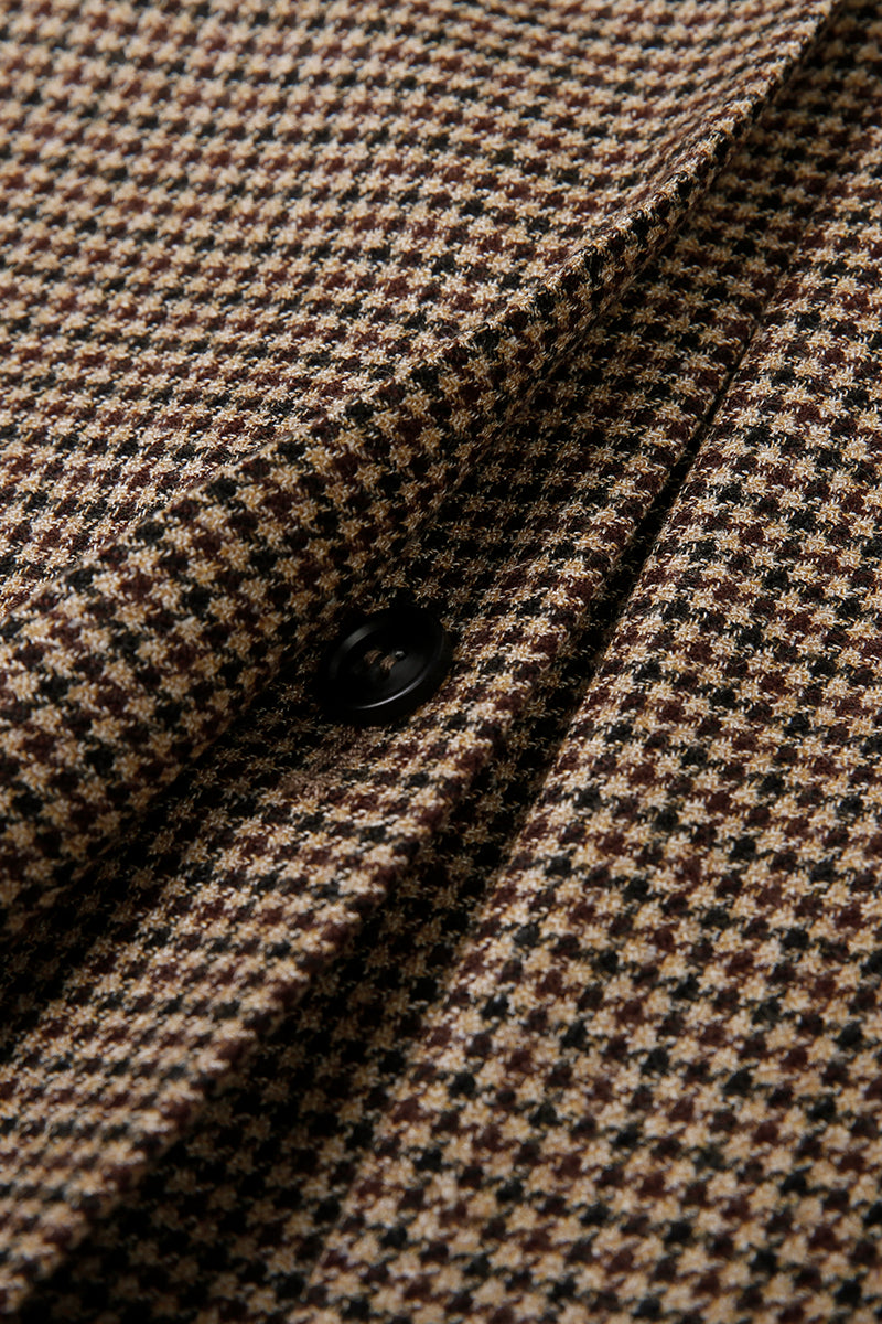Close-up of houndstooth pattern fabric with a button