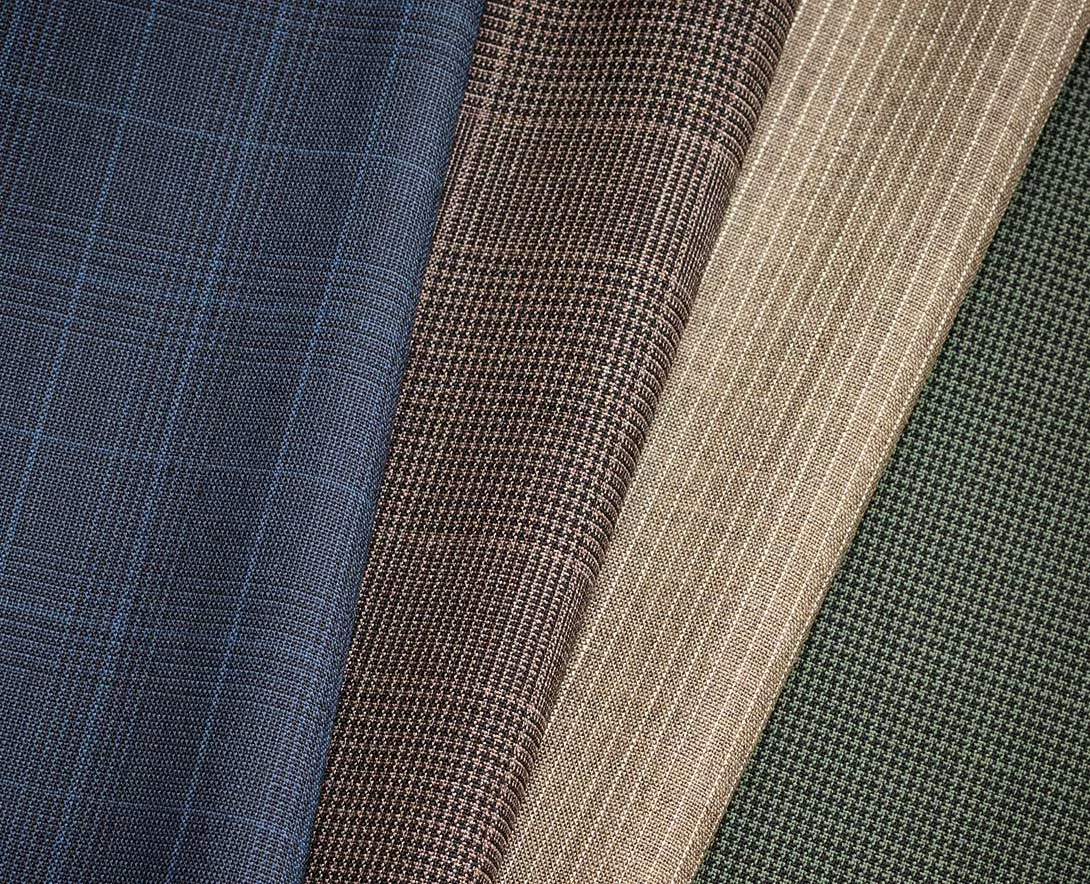 Four folded jacketing cloths: blue check, brown houndstooth, oatmeal and green