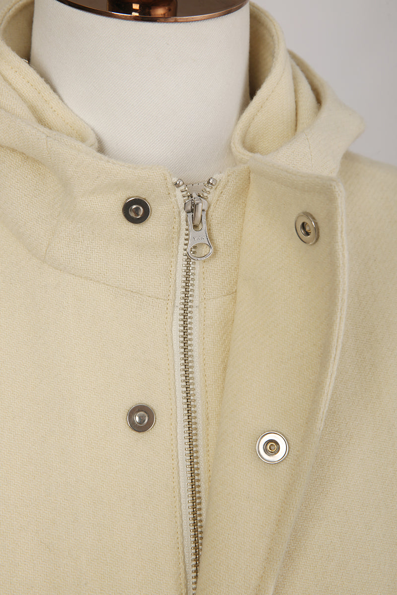 Beige hooded jacket with zipper and button details on a mannequin.