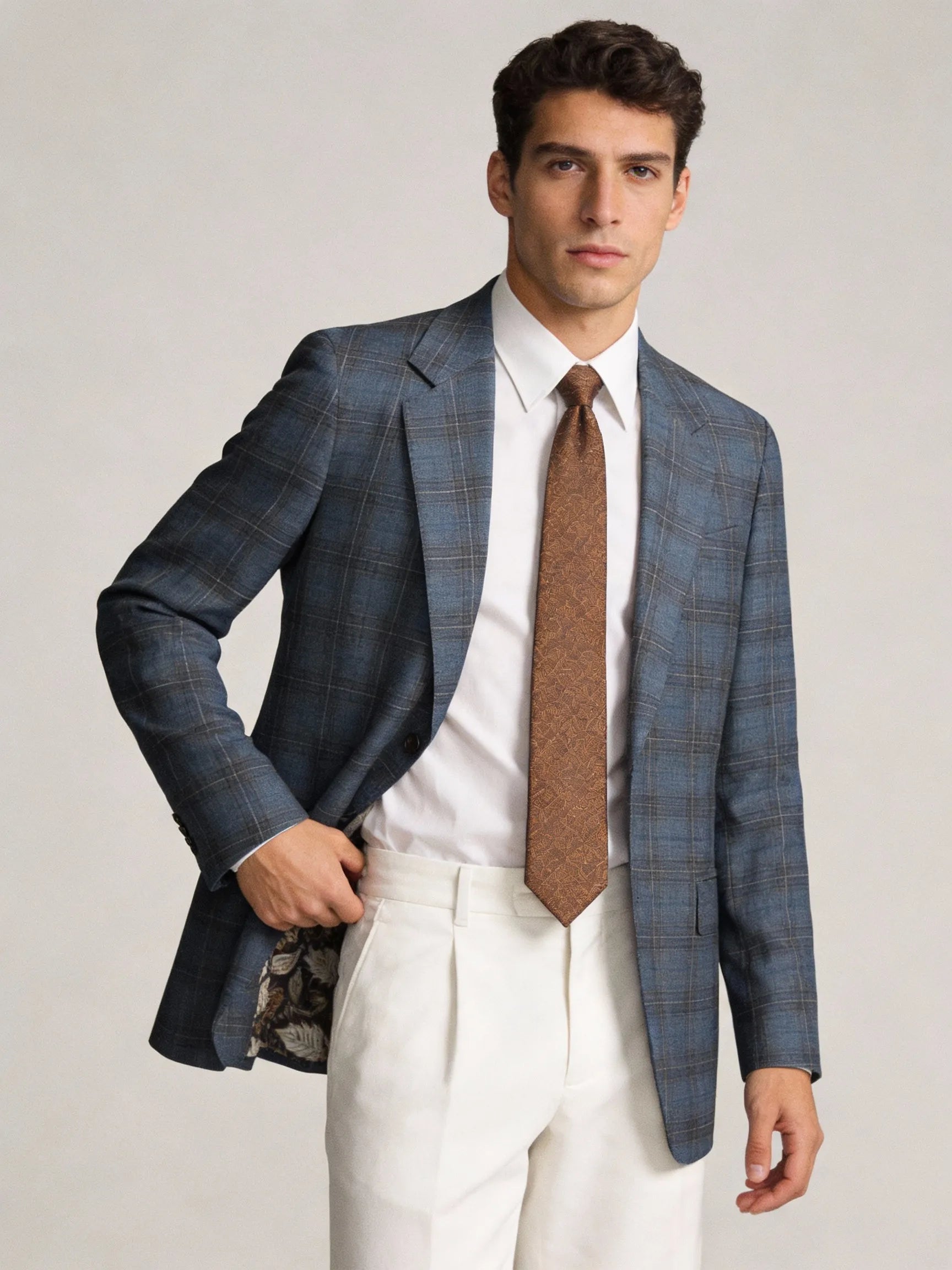 Man wearing a blue checkered suit with a brown tie italian wool blazer sport coat