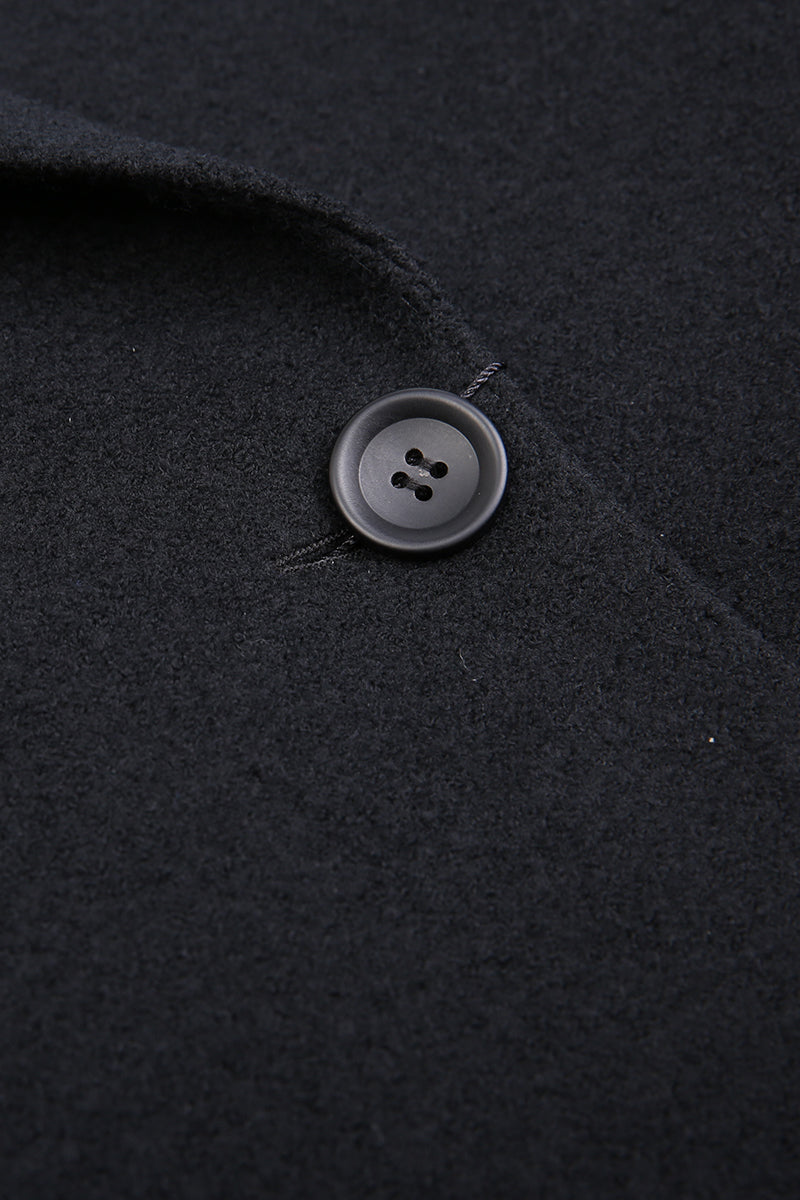 Close-up of a button on a dark fabric surface