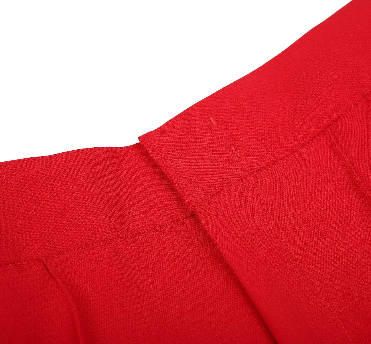Close-up of red fabric with pleated texture on a white background