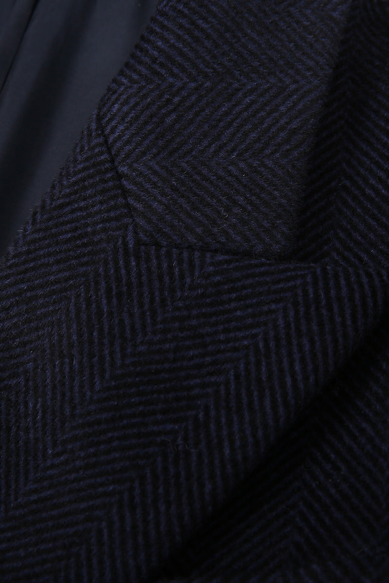 Close-up of a textured dark blue fabric with a subtle pattern.