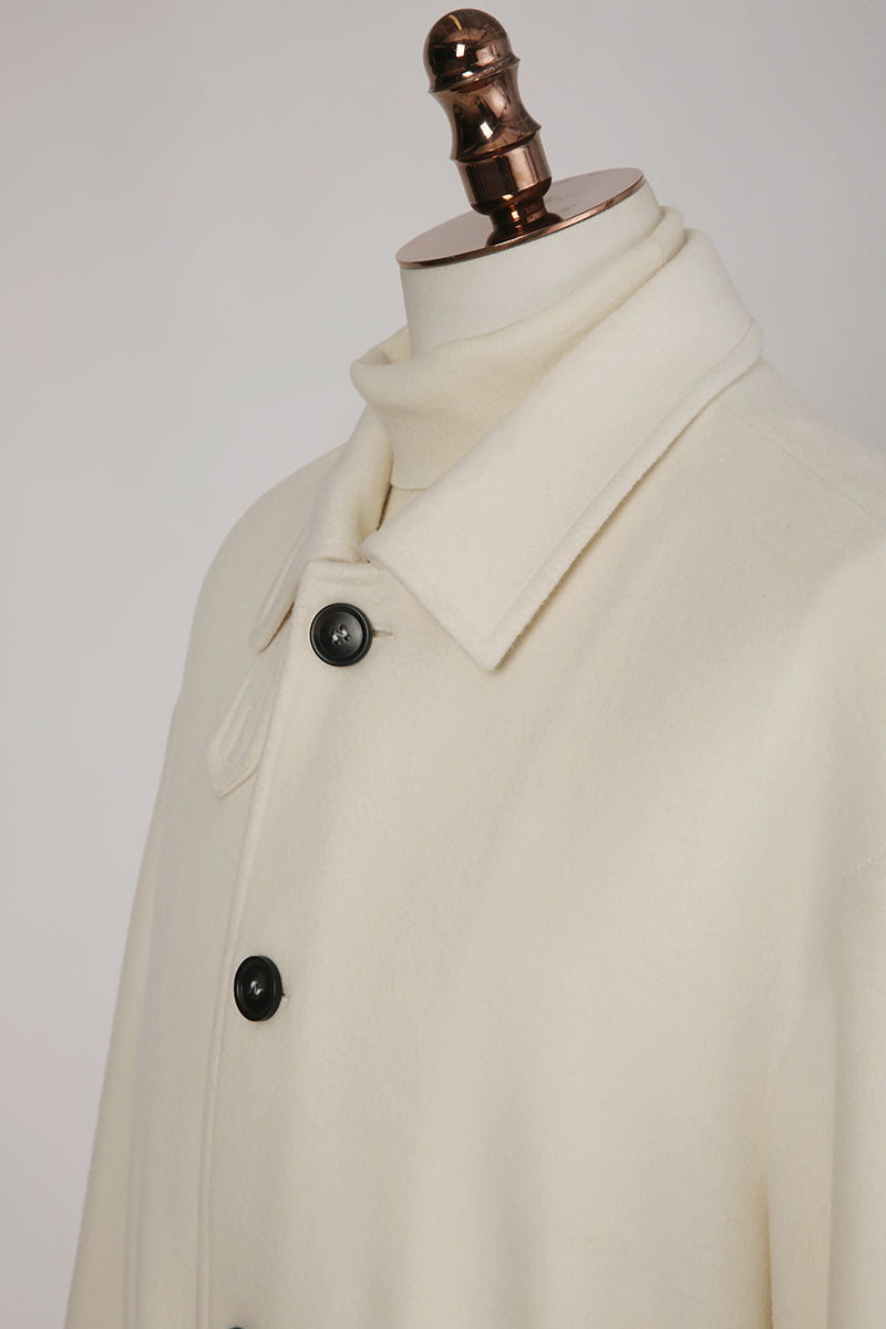 Beige coat on a mannequin with a white background