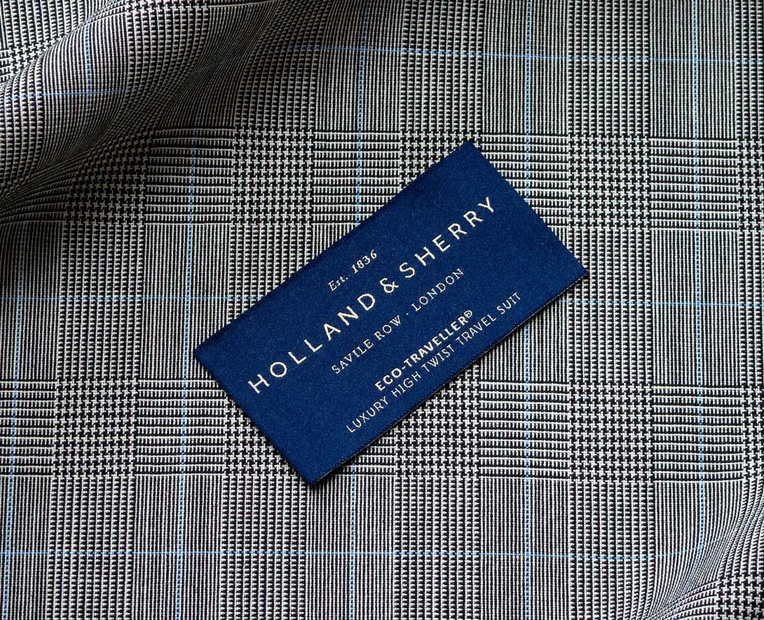 Grey checked fabric with a Holland and Sherry cloth label